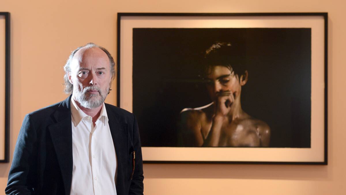 Bill Henson with one of his pieces in the Bendigo Art Gallery. Picture: Jim Aldersey
