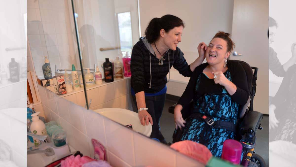 Steph Truscott puts the finishing touches on Kim Barlow for the Scope See Me September Ball. Picture: Brendan McCarthy