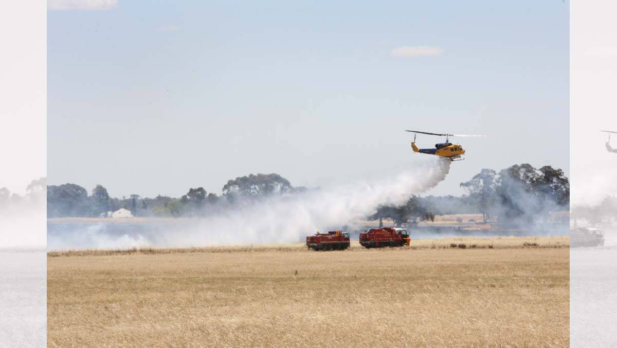 A water-bombing helicopter douses a fire at Raywood. Picture: Peter Weaving