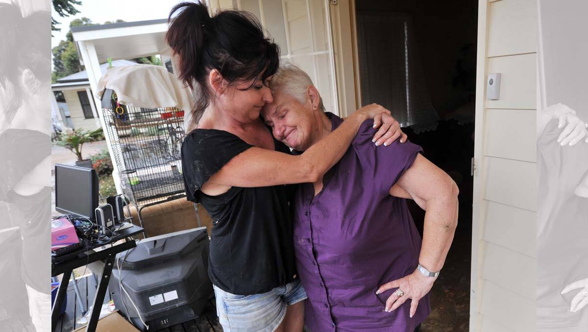 Jenny Dwyer comforts her mum Barb Templar after her cabin in Castlemaine was flooded. Picture: Brendan McCarthy