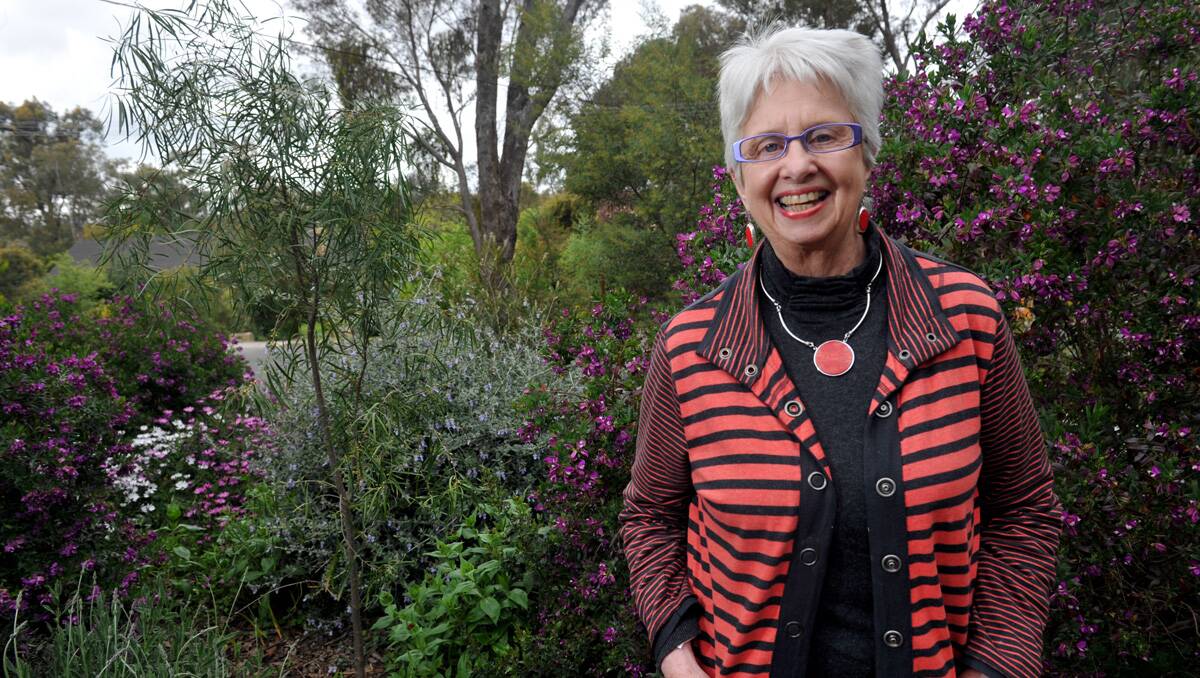 SURVIVOR: Annie Young is all smiles, while relaxing in her garden after beating breast cancer. Picture: Julie Hough