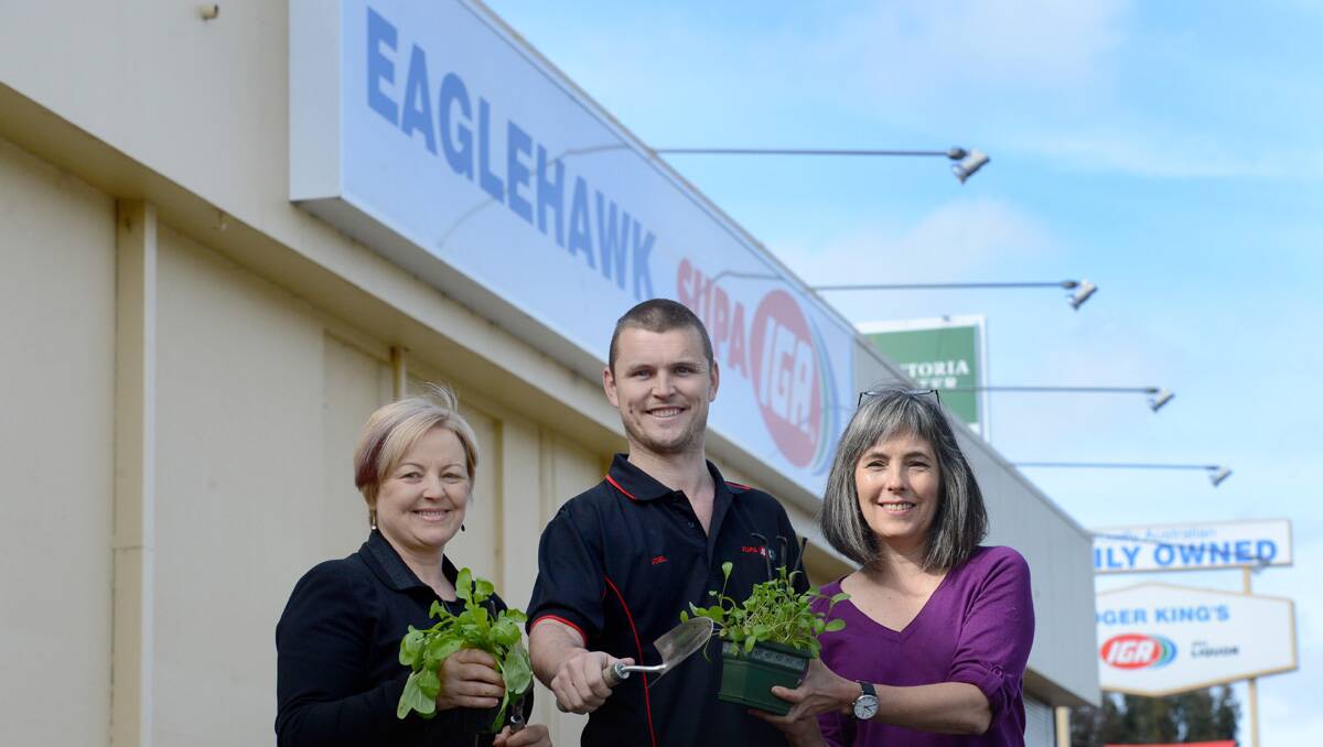 GREEN THUMBS: Jen Alden, Joel King of Eaglehawk IGA and Lisa Pola are ready to plant. Picture: Jim Aldersey