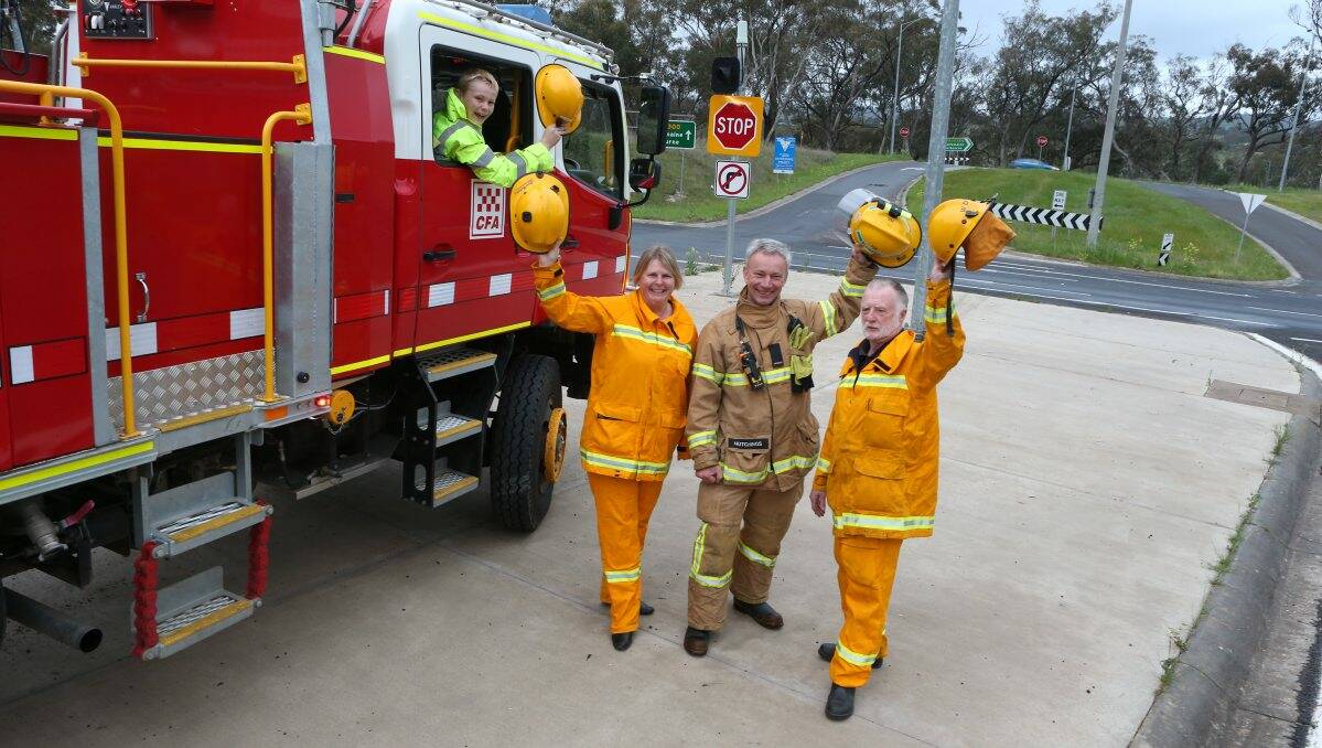  Lockwood CFA members Kathy Hogg, David Hutchings and Wayne Dyer with junior fire fighter Ben Hutchings celebrate the funding announcement at the Ravenswood intersection. Picture: PETER WEAVING