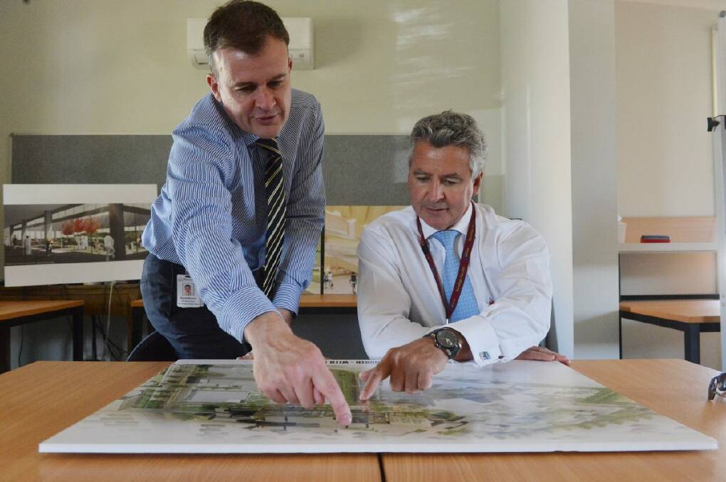 PLANS: Executive director of the New Bendigo Hospital Project David Walker and Bendigo Health chief executive officer John Mulder inspect plans for the new hospital development.  Picture: BRENDAN McCARTHY