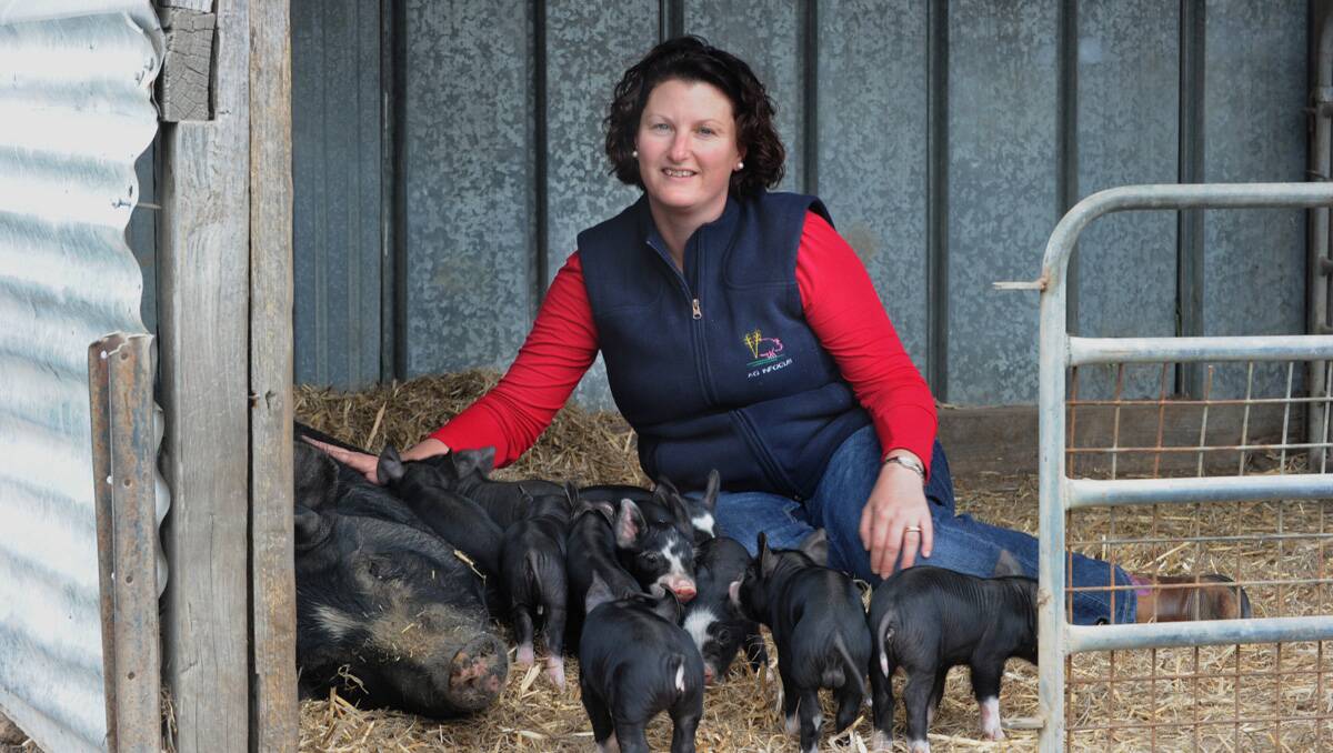 SUSTAINABLE: Belinda Hagan on the farm with some new additions to the pigs she and husband Jason raise. Picture: Peter Weaving