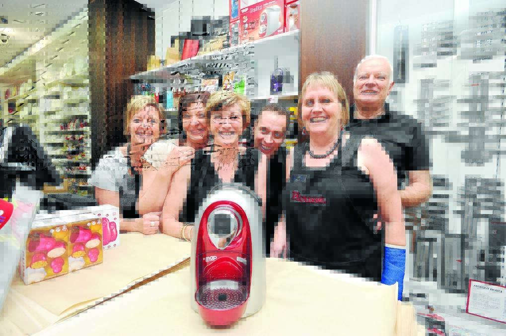 HECTIC: House staff members Diane Gray, Nevis Myers, Sharon Newton and Sean, Julie and Stephen Guild, pictured with one of the best sellers in the lead-up to Christmas – a coffee machine. Picture: JODIE DONNELLAN