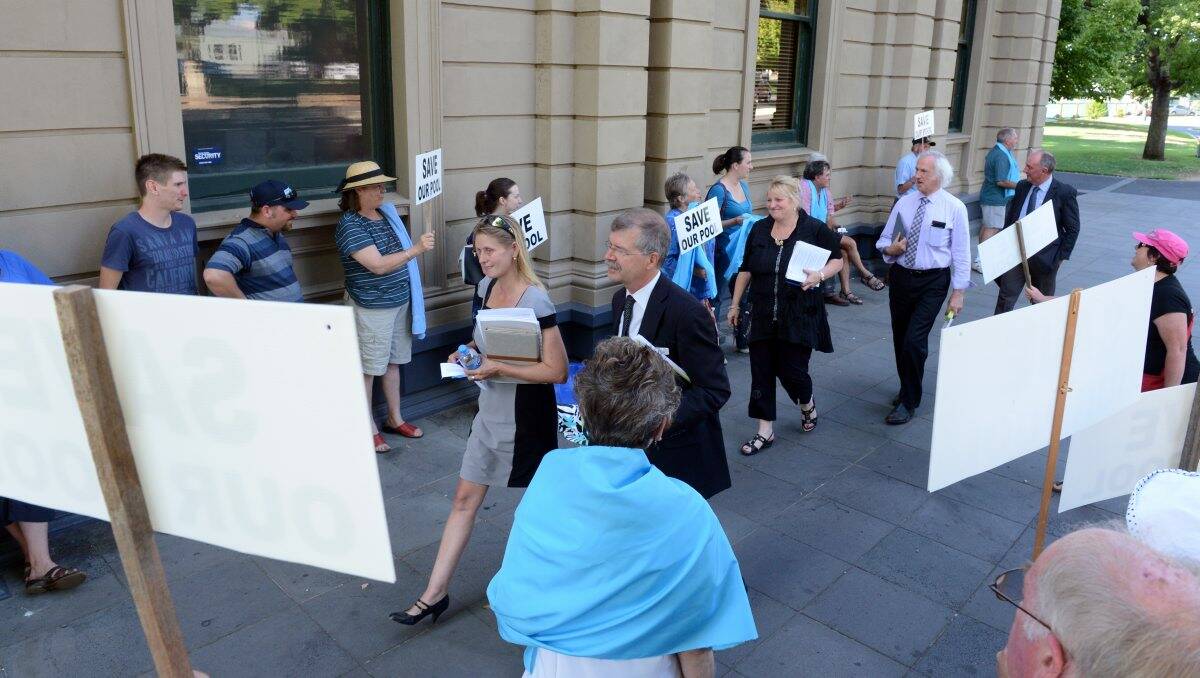 DISCONTENT: Elise Chapman, Peter Davies, Mayor Lisa Ruffell, Rod Fyffe and James Williams walk past protestors.Picture: JIM ALDERSEY 