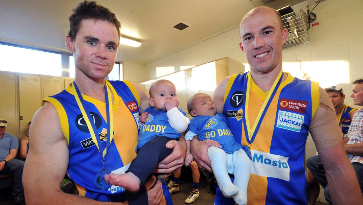 BFNL grand final. Christian Carter with his 6-month-old daughter Poppy and Mark Lloyd with his 1-month-old son Alfie. Picture: Julie Hough