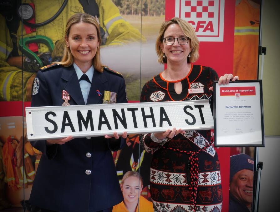 CFA chief executive Natalie MacDonald presenting a road sign to Samantha Rothman. Picture: SUPPLIED