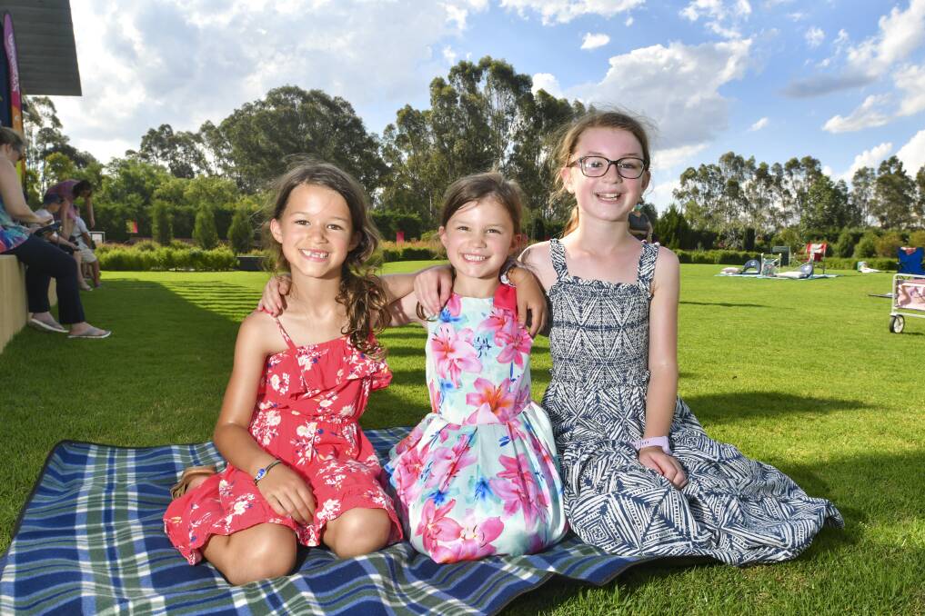 FUN: Isla, Edie and Lucy Patching enjoy the free outdoor screening of Mary Poppins Returns. Picture: NONI HYETT