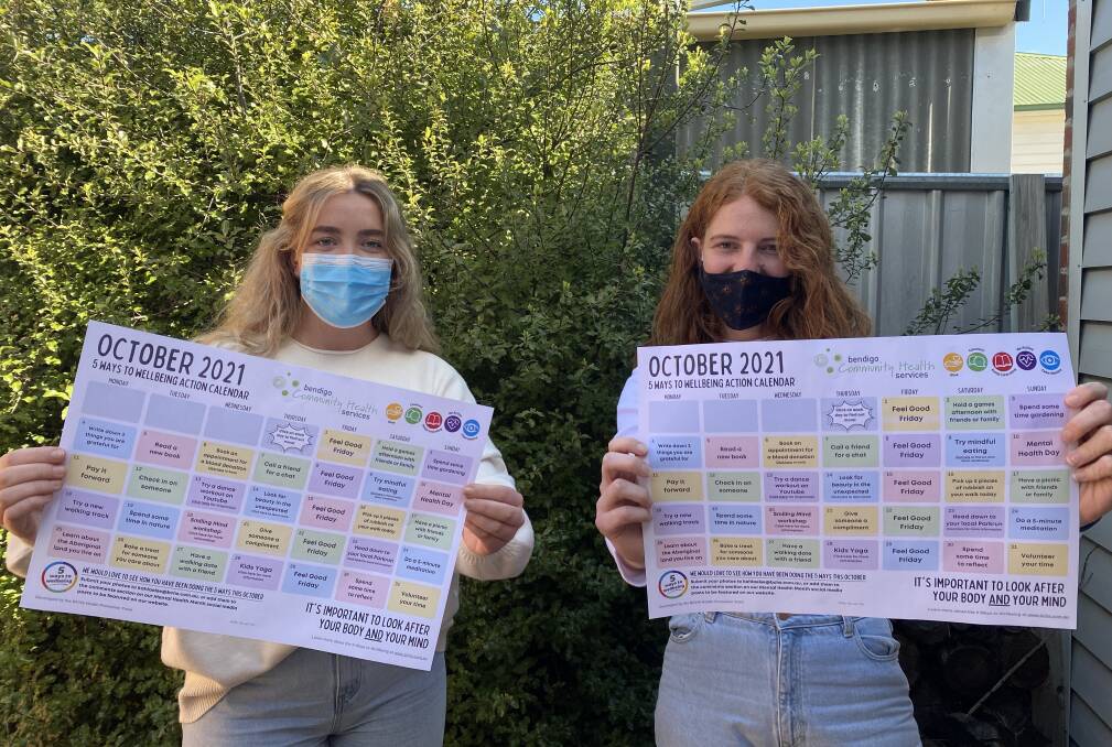 Bendigo Community Health Services Health Promotion project workers Georgia Linehan and Kahla Else with the October Action Calendar. Picture: SUPPLIED 