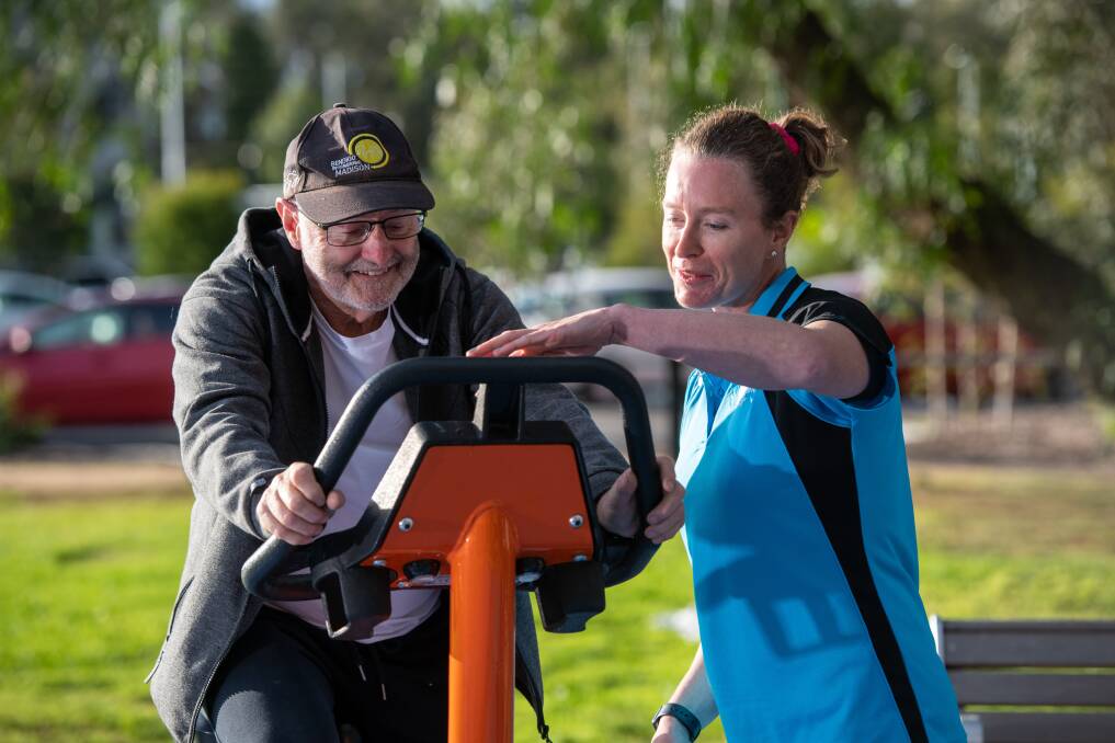 EXERCISE: The campaign will offer a range of free outdoor exercise sessions over three weeks. Resident Ken Smith with trainer Claire Ellis using some of the free equipement. Picture: SUPPLIED