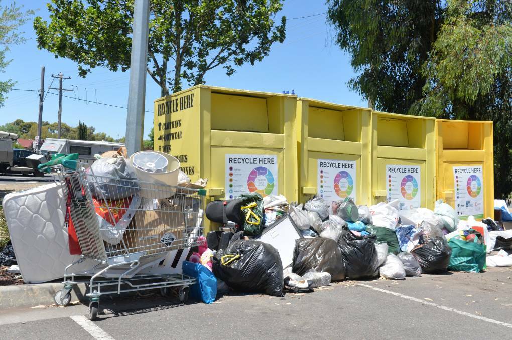 
PROBLEM: Piles of goods left outside recycling bins for a for-profit enterprise in Bendigo a few years ago. Charities experience the same issue and urge people to leave goods at op shops during business hours. Picture: DARREN HOWE
