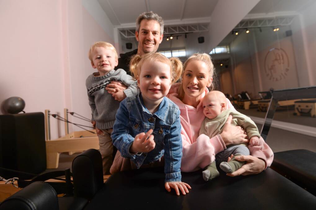 SUCCESS: Stacey and Brad Cossar have opened a Pilates studio in Bendigo after a difficult six years. The couple is pictured with children Sid, Elsie and baby Ned. Pictures: DARREN HOWE