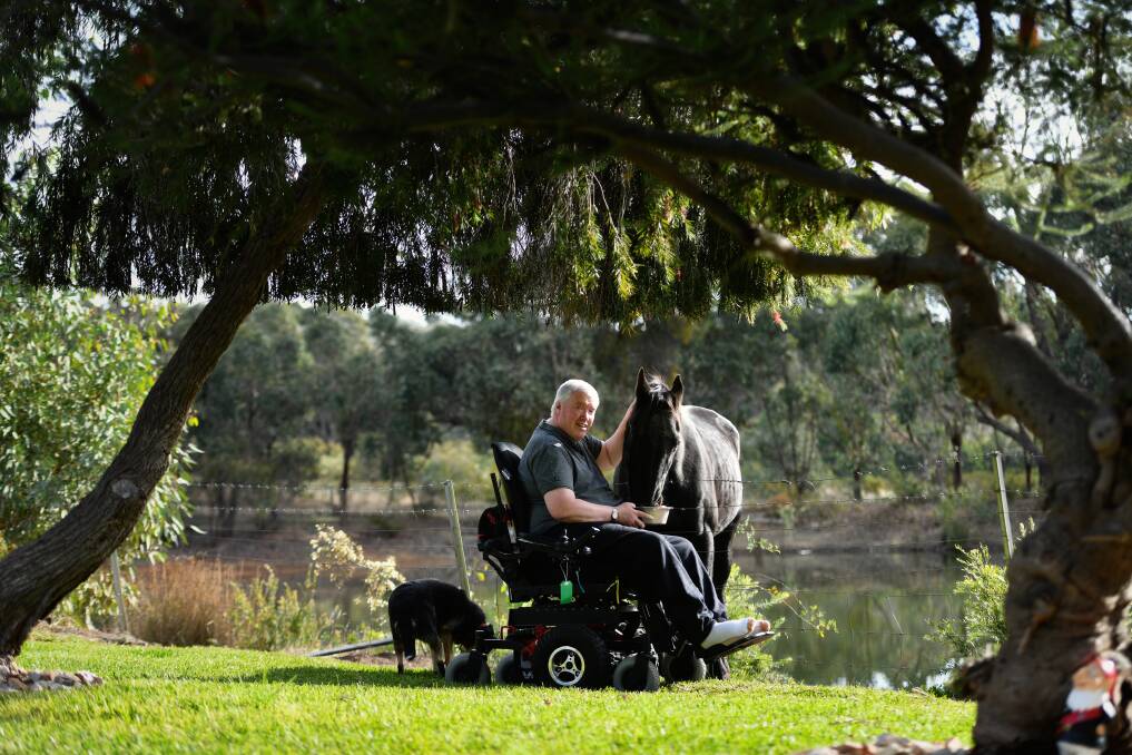 AWARENESS: Rod Case is raising awareness for MND. He thanks his loving support system which includes his wife, his dog and horse. Picture: DARREN JAMES 