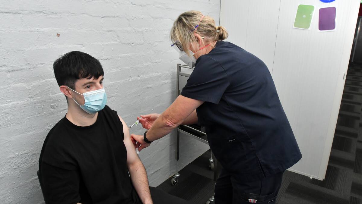 MILESTONE: Bendigo resident Sam Garland's vaccination helped tip the region over the 70 per cent double dose mark. Nurse vaccinator Jo McCann administered the vaccine. Picture: NONI HYETT