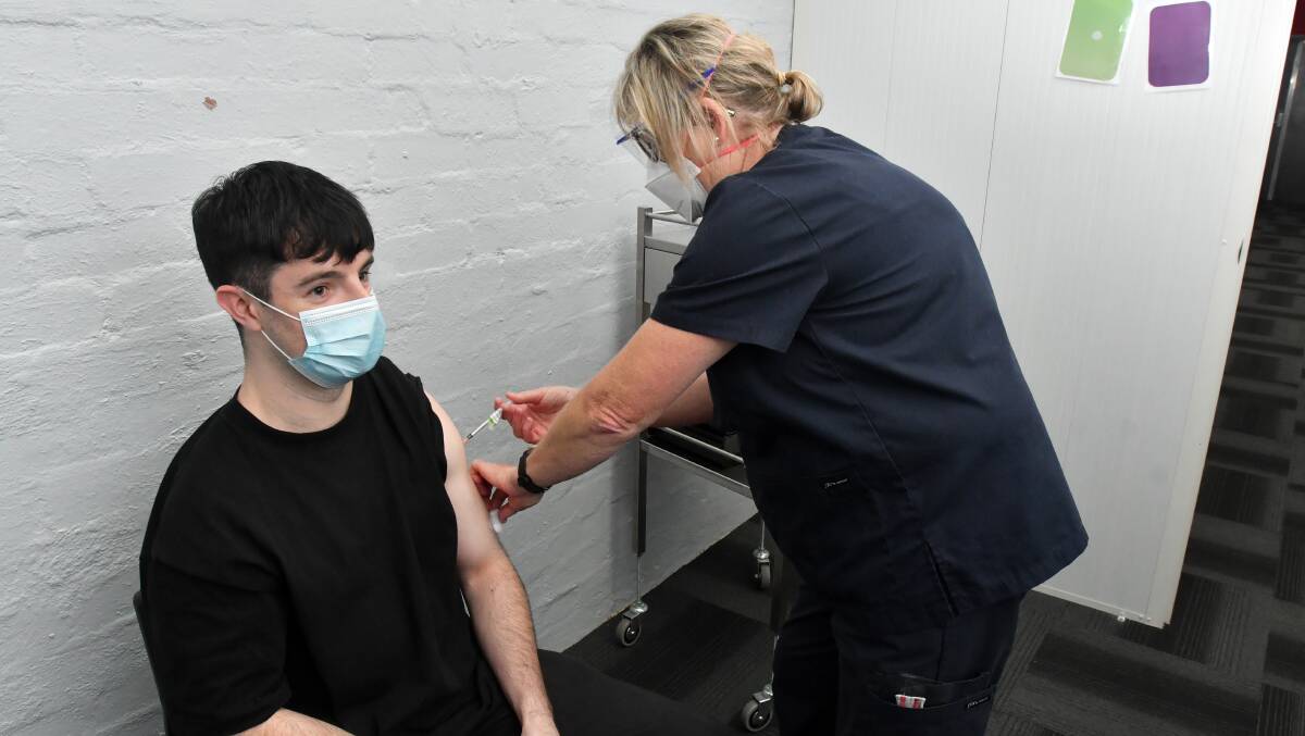 MILESTONE: Bendigo resident Sam Garland's vaccination helped tip the region over the 70 per cent double dose mark. Nurse vaccinator Jo McCann administered the vaccine. Picture: NONI HYETT