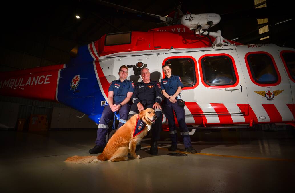 CALLING IT: Justin Nunan is retiring after many years as MICA flight paramedic. Justin is with his son Benjamin Nunan, future daughter in law Elise Paton and assistance dog Daisy. Picture: DARREN HOWE