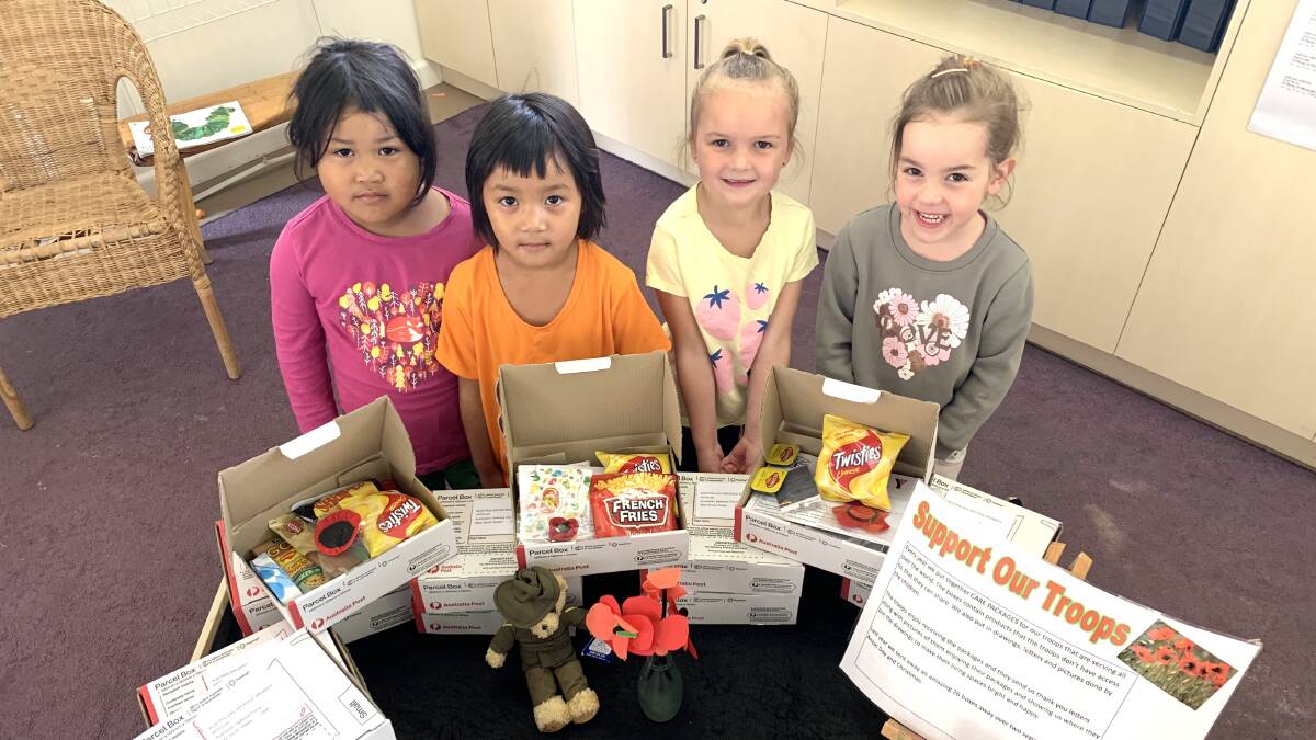 HELPING HANDS: Havilah Road Preschool children Emily, Amber, Amity and Ciara are excited to send off their care packages. Photo: ALLANAH SCIBERRAS