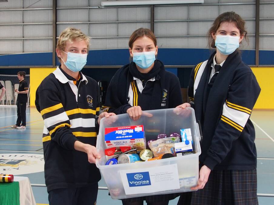 Catherine McAuley student leaders Jack Osborne, Lucy Sherriff, Maya Flood with a box of donations. Picture: SUPPLIED