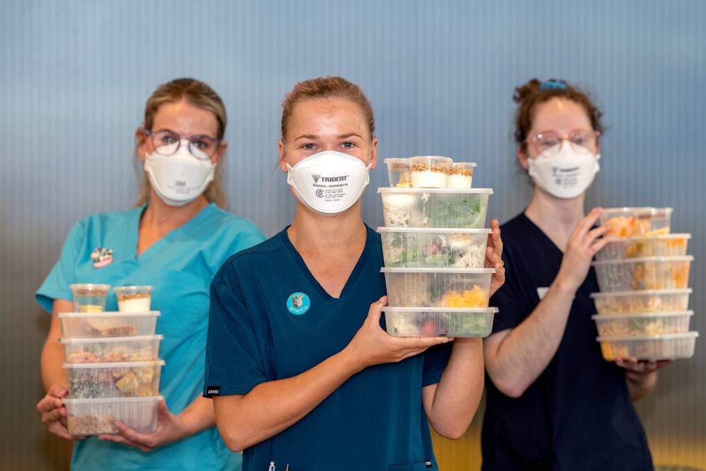 Bendigo Health staff Brittney Poole, Whensday Shearman and Gabbie McKenzie with meals donated by Fresh-5. Picture: KATE MONOTTI