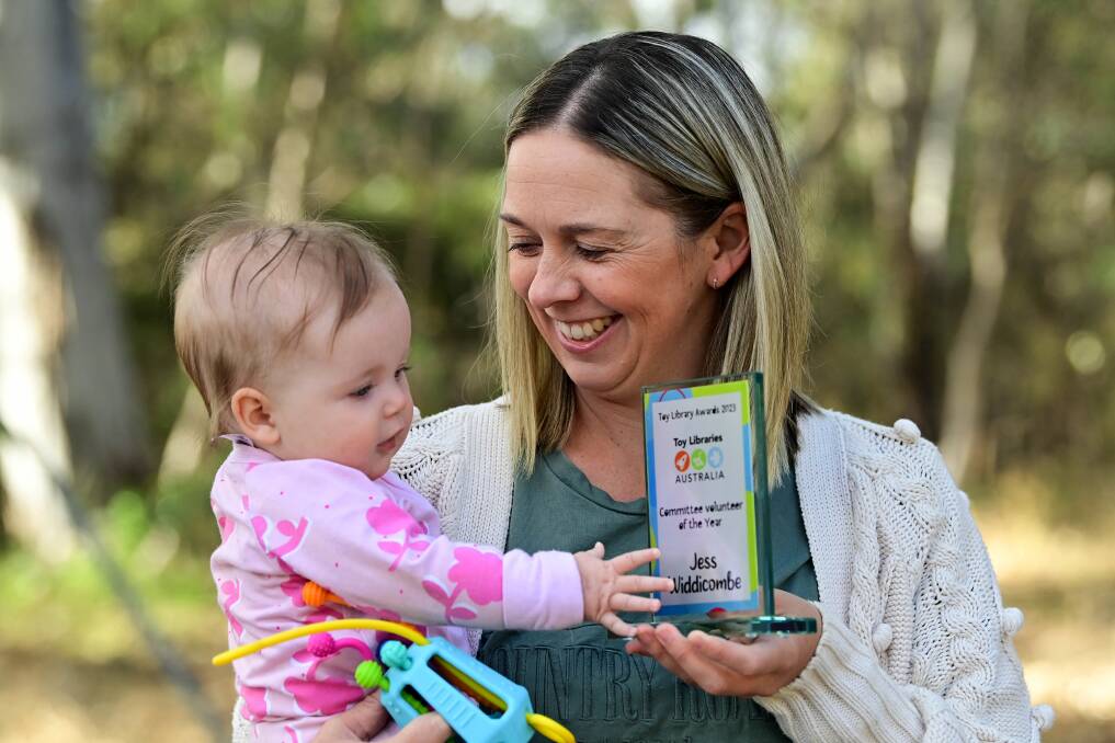 Bendigo Community Toy Library committee president Jess Widdicombe with her daughter and the Committee Member of the Year award. Picture by Brendan McCarthy