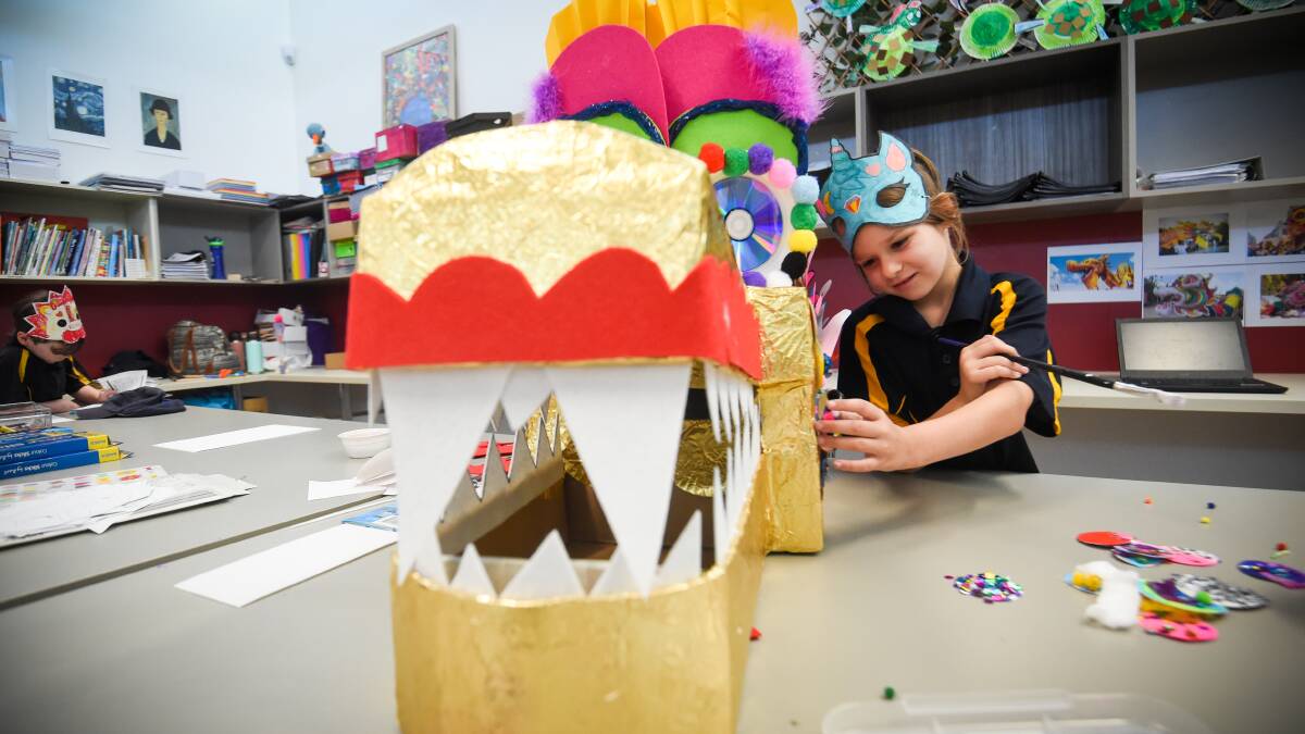 DRAGON TASK: Kalianna School student Emma Ferrari helps with making the school's dragon head for the 150th Easter Fair. Picture: DARREN HOWE