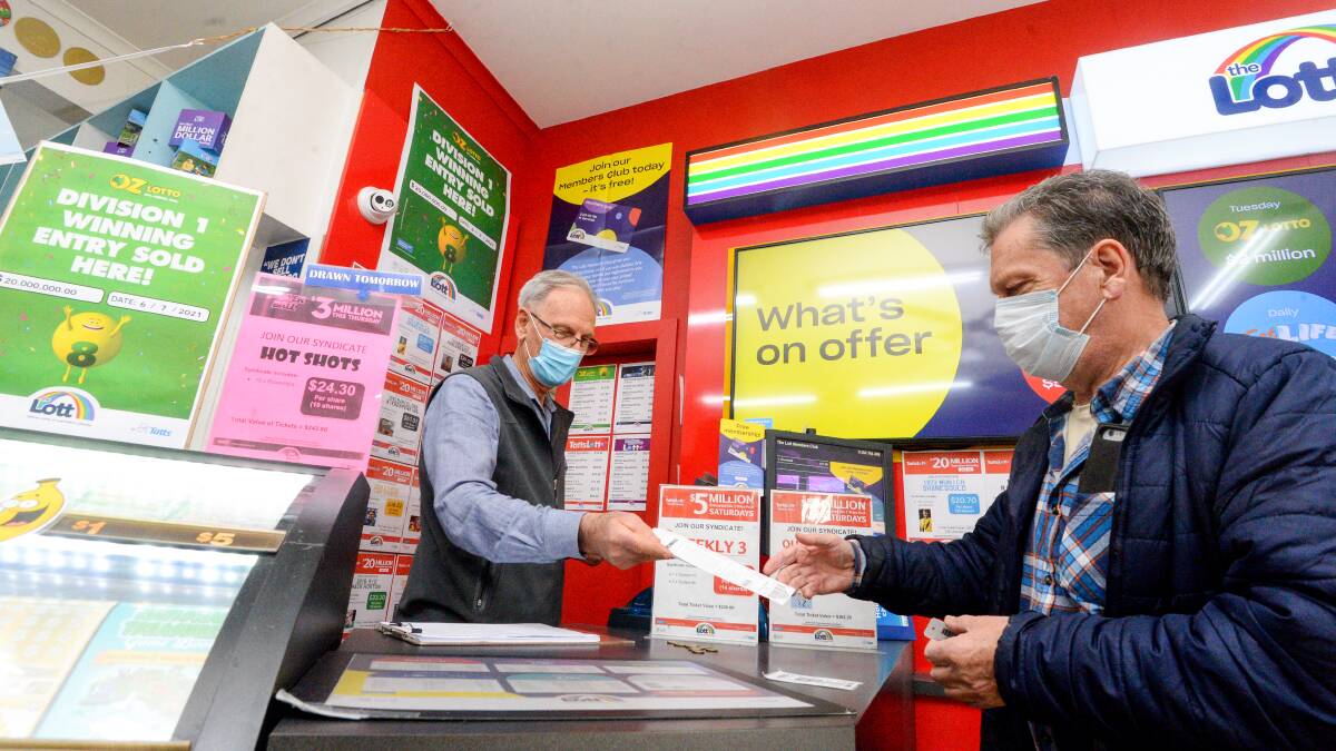 Golden Square Newsagency owner Bill Roberts selling a ticket to a customer. Picture: DARREN HOWE