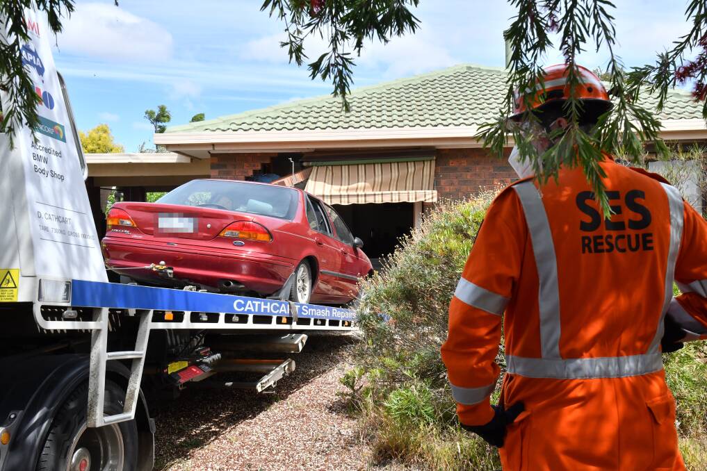 A tow truck was used to remove the car from the house in Eaglehawk. Picture: NONI HYETT