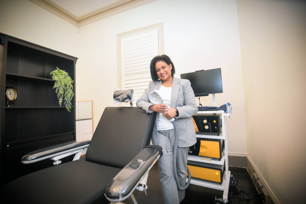 OPEN SOON: Theta Clinic's Dr Dilani Daluwatte with the rTMS machine. Picture: DARREN HOWE