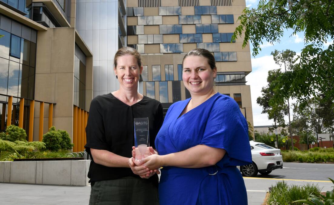 Narelle McPhee and Chloe Georgiou with their team's Australasian Gastro-Intestinal Cancer Trials Group (AGITG) award. Picture by Noni Hyett