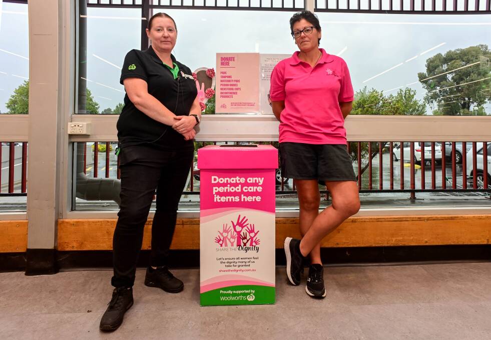 Woolworths Goldn Square Customer Service manager Michelle Olsson and Share the Dignity volunteer Janet O'Brien with a donation station. Picture by Brendan McCarthy