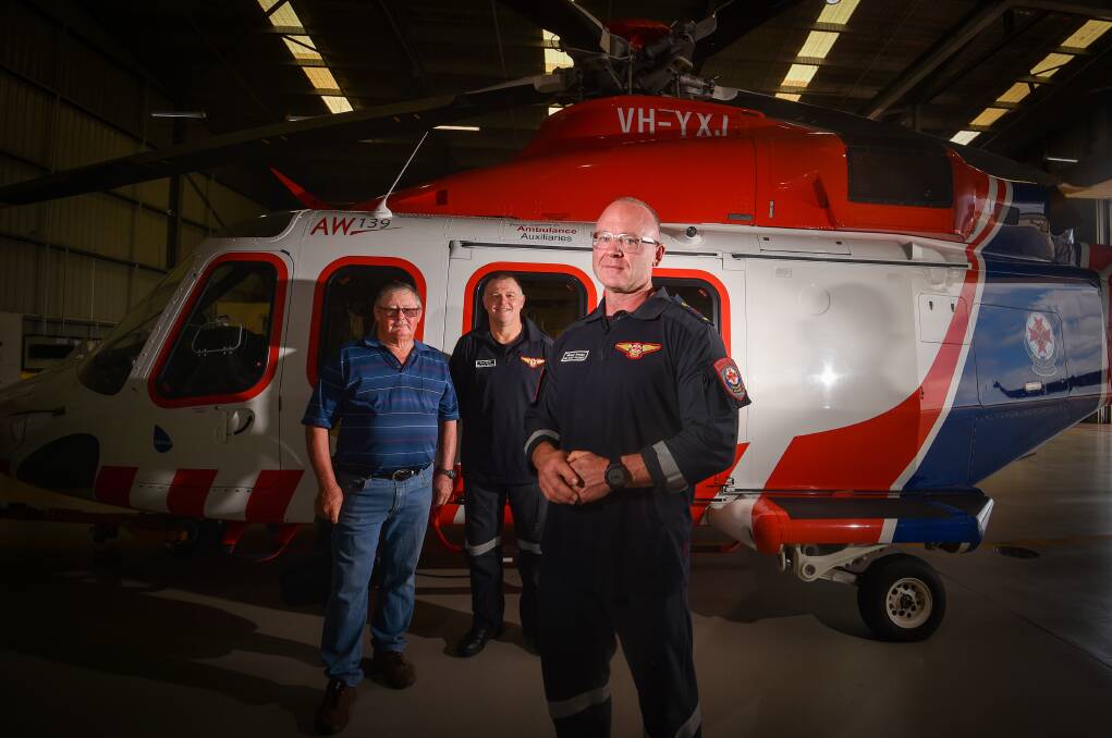 A friend of the couple Bruce Salter, Brad Martin and Michael Whelan in front of the HEMS 3 air ambulance in Bendigo. Picture by Darren Howe