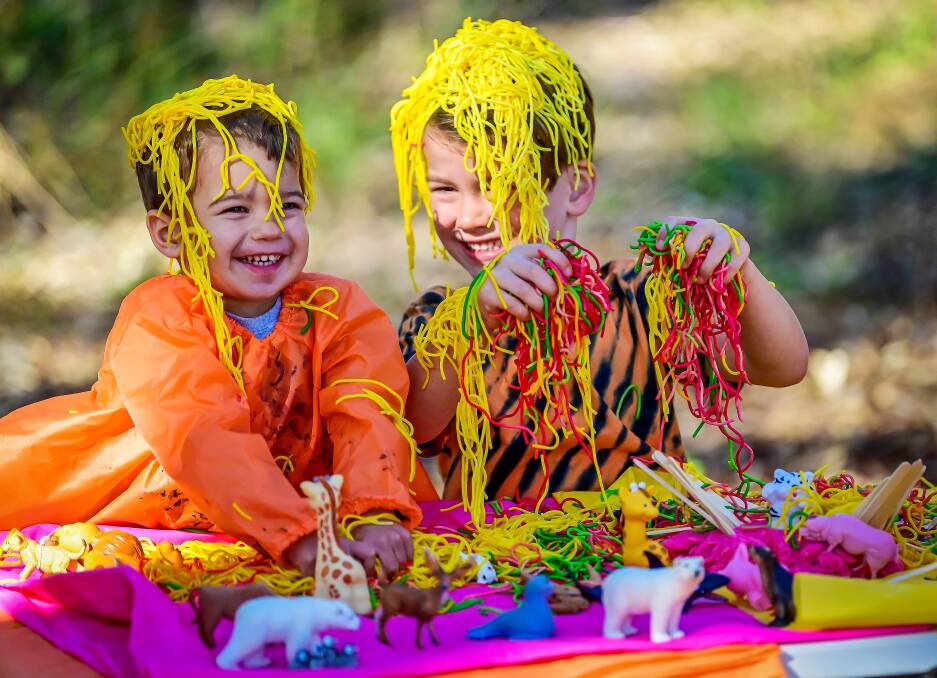 Oakley Jackson and Angus Bourke helping promote last year's messy play day at the library. Picture by Brendan McCarthy