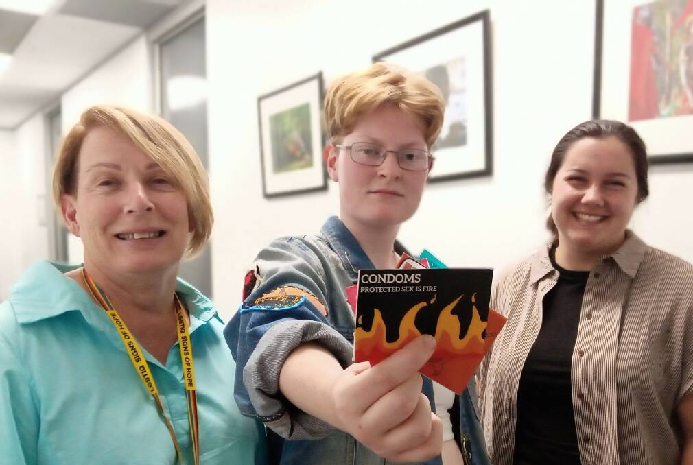 Mary-Anne McCluskey, Jay Moore and Ella Westblade with the new condom packet design. Picture supplied