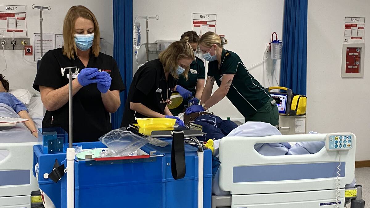 Nursing and paramedic students performed a simulation of how different health care workers interact during the funding announcement on June 25. Picture: ALEX GRETGRIX