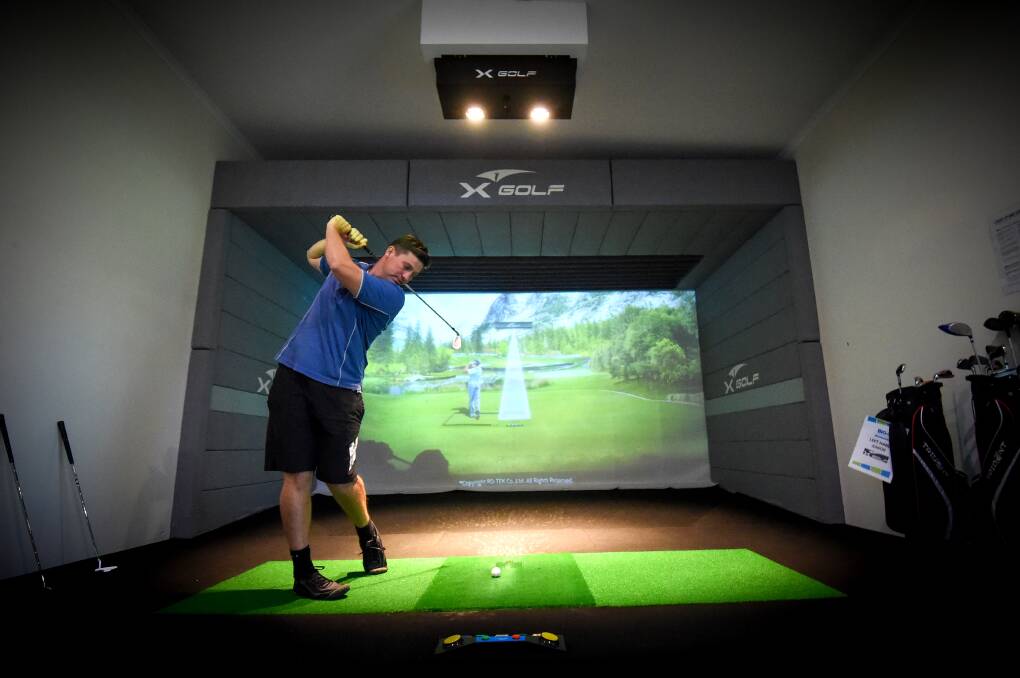 The news X-Golf simulator is a first for holiday parks in Australia. Picture: DARREN HOWE 