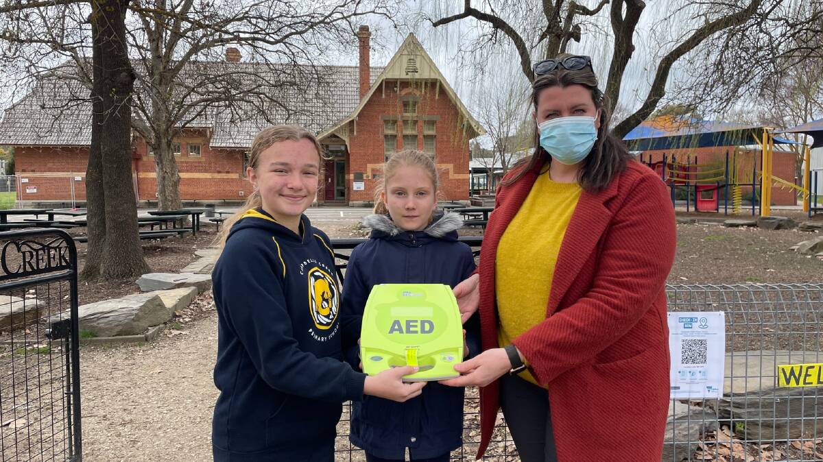 Staff and students from Campbells Creek Primary School with their new defib machine. Picture: SUPPLIED