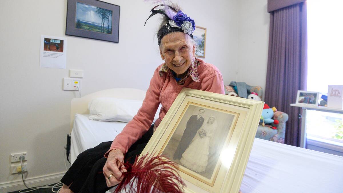 Bonnie Mitchell with one of her wedding photos. Picture: DARREN HOWE