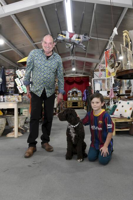 BUSINESS IS BOOMING: Mark Ward, owner of The Amazing Mill Markets in Daylesford, with his eight-year-old son, Archer and their dog Ruby. Picture: Lachlan Bence