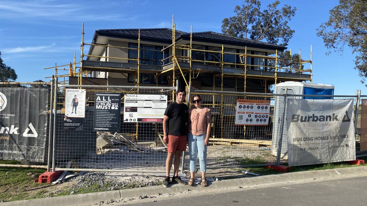 Alanna Tomazin with her brother, Nicolas, in front of the partially-built family home they bought in the NSW Hunter region to help their parents. Picture: Supplied