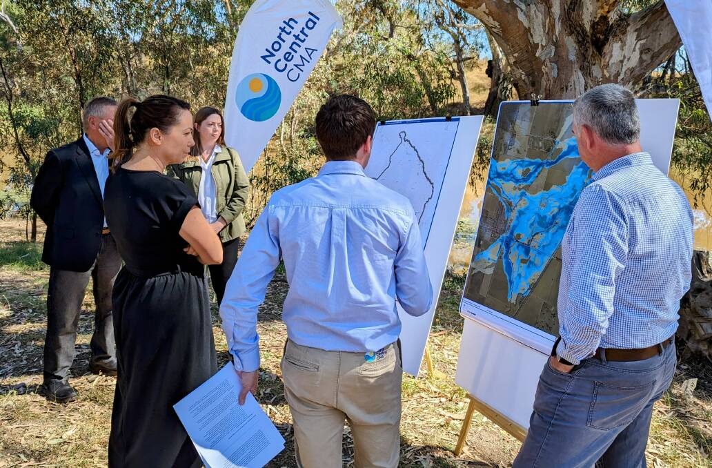 Victorian Minister for Emergency Services Jaclyn Symes looks over some flood mapping at the funding announcement in Newbridge last week. Picture supplied.