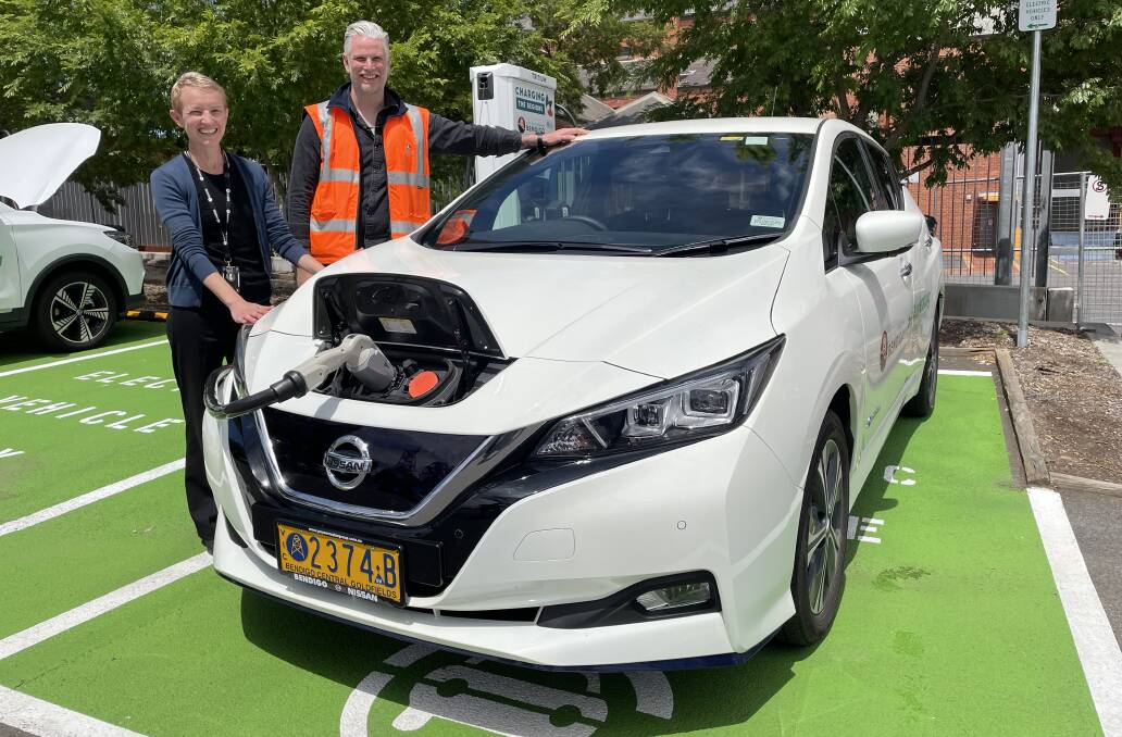 CHARGING ON: City of Greater Bendigo climate change and environment manager Michelle Wyatt and fleet manager Luke Shaw at the charging station installed at the QEO car park. Picture: DAVID CHAPMAN