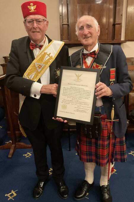Deputy for the Province of Victoria for the Scottish Rite of Freemasonry Neil Nyholm (left) presents the Distinguished Service Diploma to Bendigo's Graeme Turpie. Picture supplied