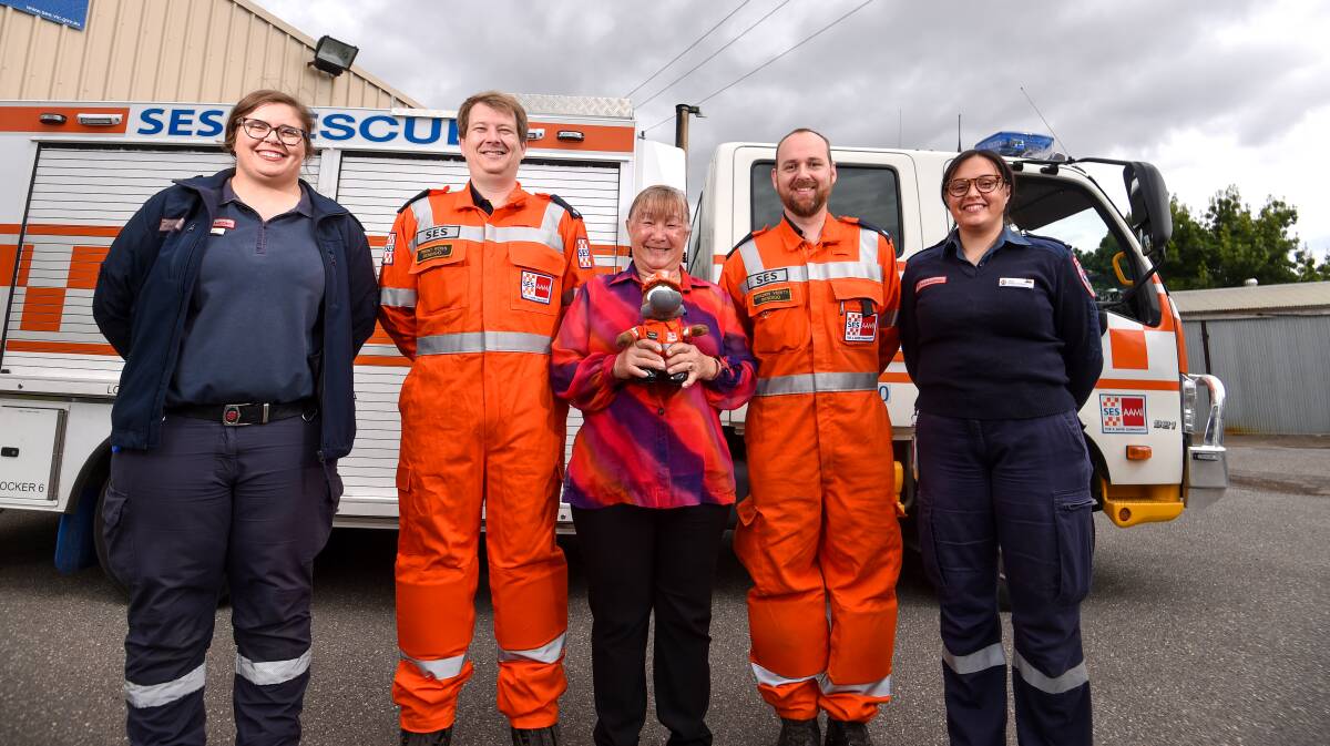 Marlene Wing-Quay with her saviours from that harrowing night in floodwaters - (from left) paramedics Aleisha Rutland, SES volunteers Trent Ross and Braden Verity and paramedic Dani Turner. Picture by DARREN HOWE