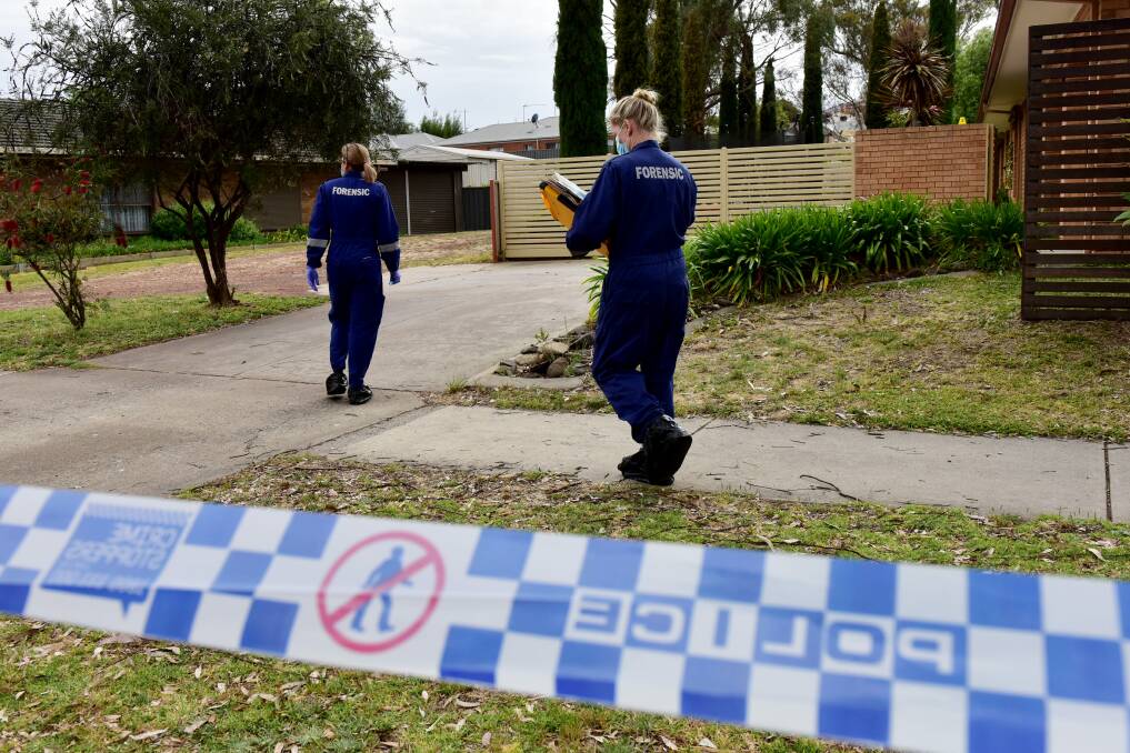 Forensics team investigate at a house in Kangaroo Flat, the scene of an alleged homicide. Pictures by Brendan McCarthy