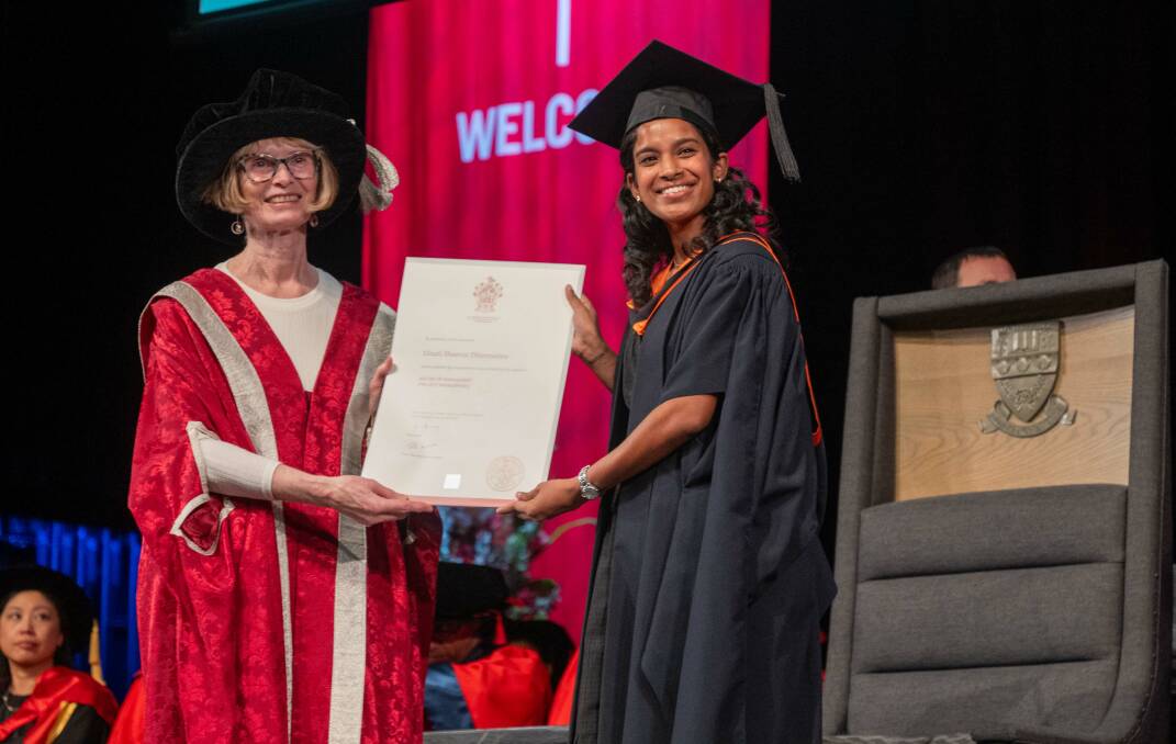 Deputy Chancellor Margaret Burdeu presents Dinali Shaeron Dharmadasa with her certificate at the graduation ceremony. Picture by Enzo Tomasiello