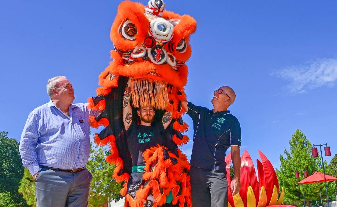 Golden Dragon Museum CEO Hugo Leschen (left) and Bendigo Chinese Association president Doug Lougoon (right) with LION Team member Shai Watts are ready to celebrate Chinese New Year next week. Picture: BRENDAN McCARTHY