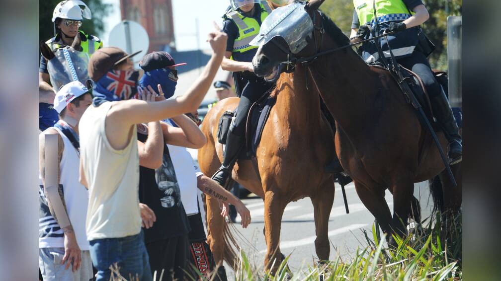 Police try to move anti-Mosque protesters on from the Bendigo Train Station's car park in 2016. Picture by DARREN HOWE