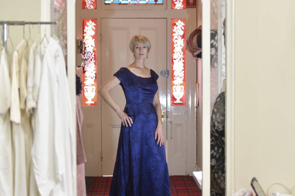 BYGONE ERAS: timeless evening gowns are mixed with more obviously antique pieces at the Bendigo Historical Society pop up shop. Picture: NONI HYETT 